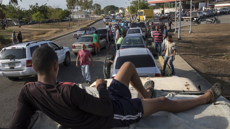 Satellite photos show mile-long gasoline lines in oil-rich Venezuela